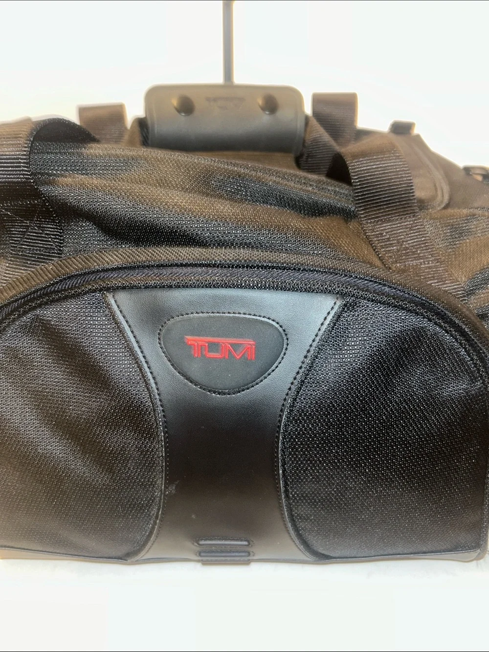 Tumi Black Duffel Bag with Red Logo Accent